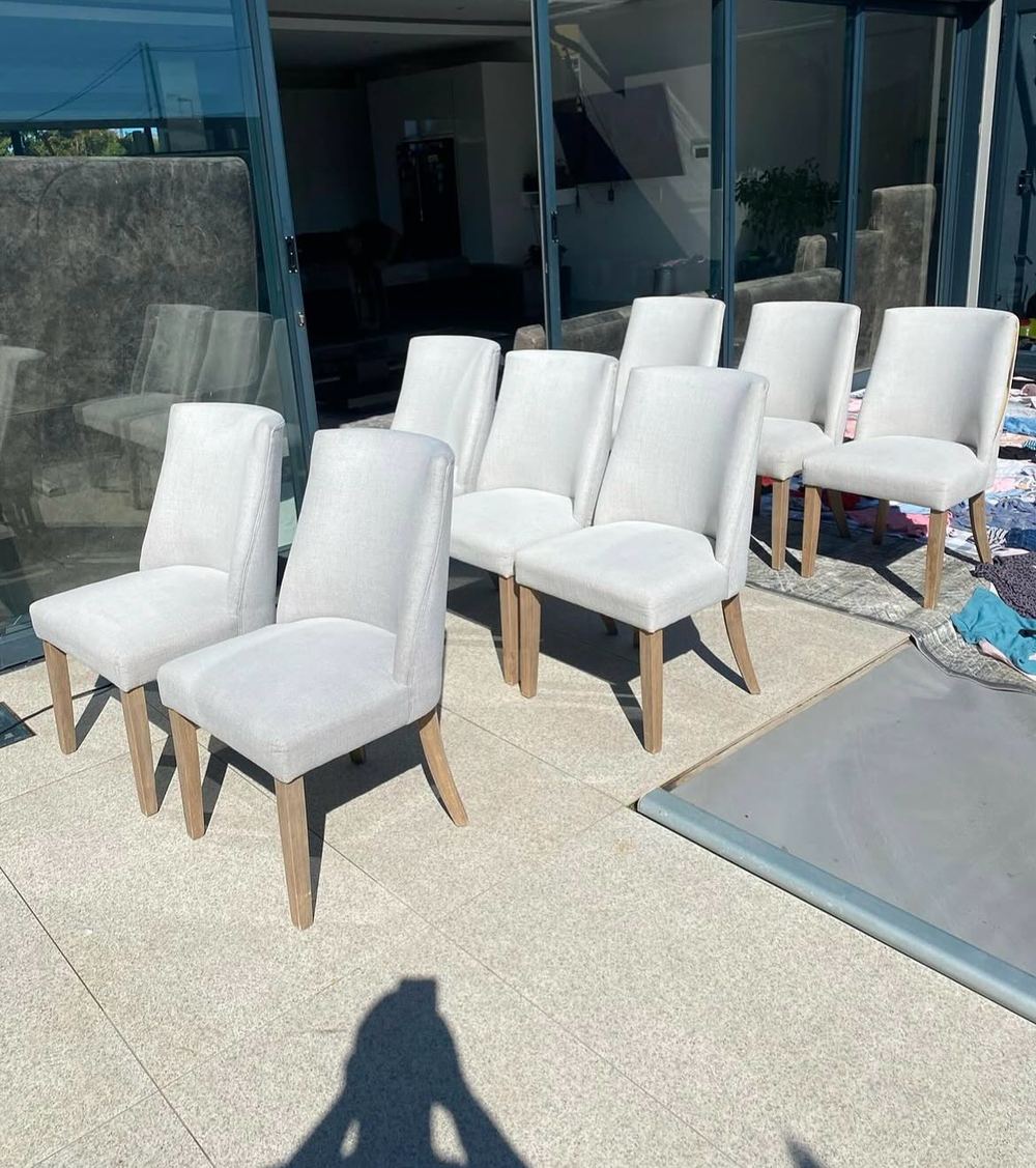 A full dining chair set cleaned and staged after upholstery treatment