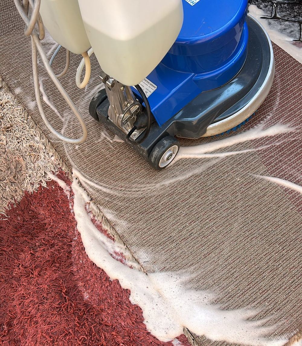 Rotary scrubbing a wool rug on site